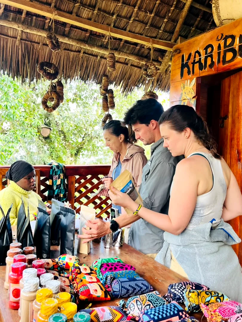 Guests at the Karibu table choosing bags of coffee and jars of spice