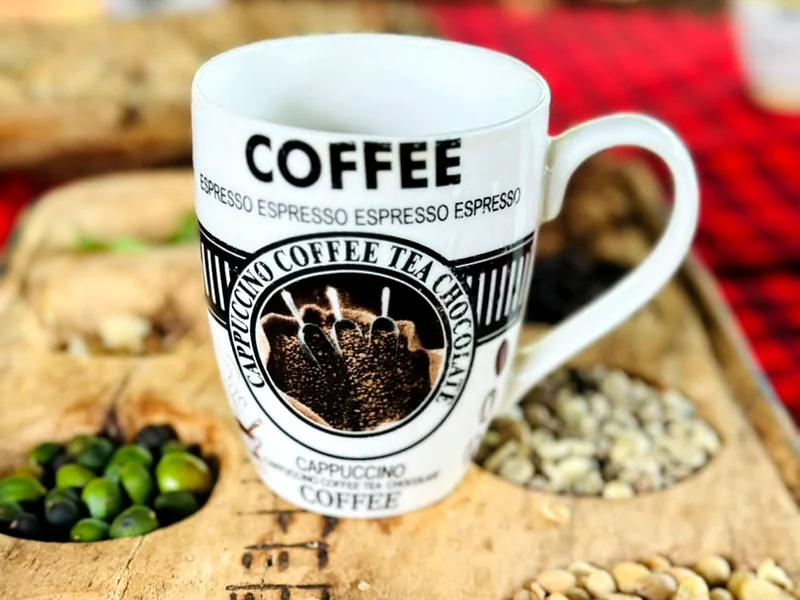 A mug of Materuni coffee on the carved tray that holds every stage of the bean