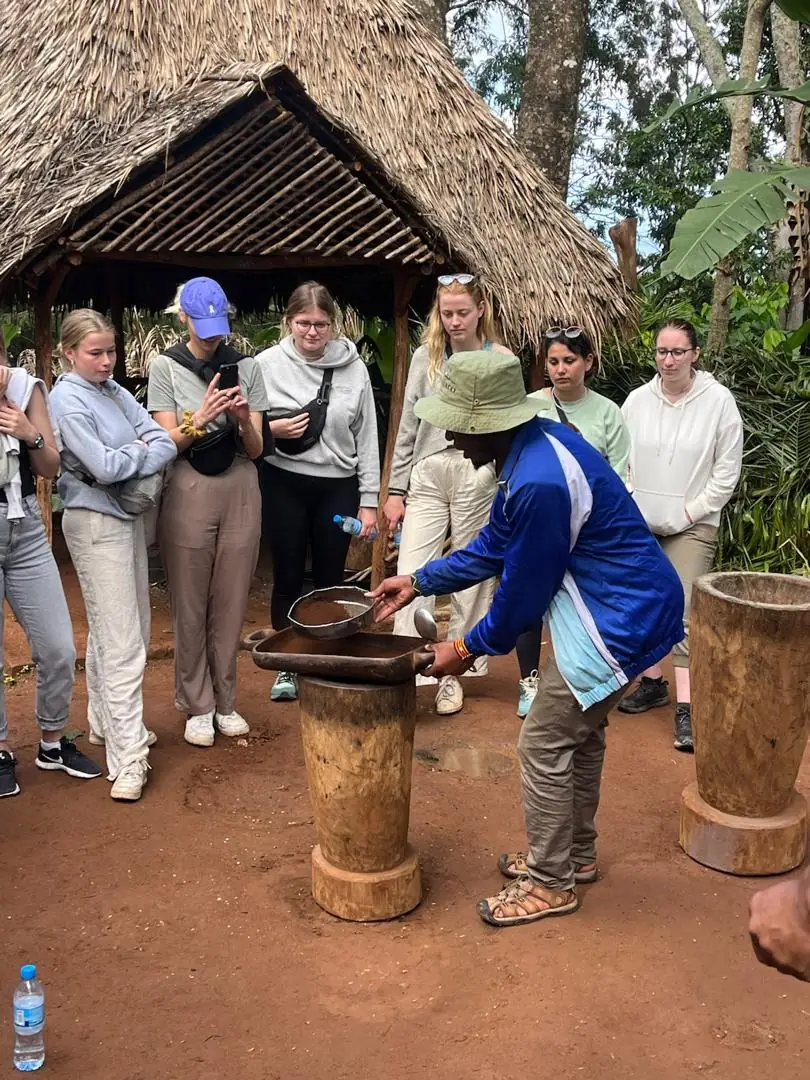 The mortar being worked while the group gathers around